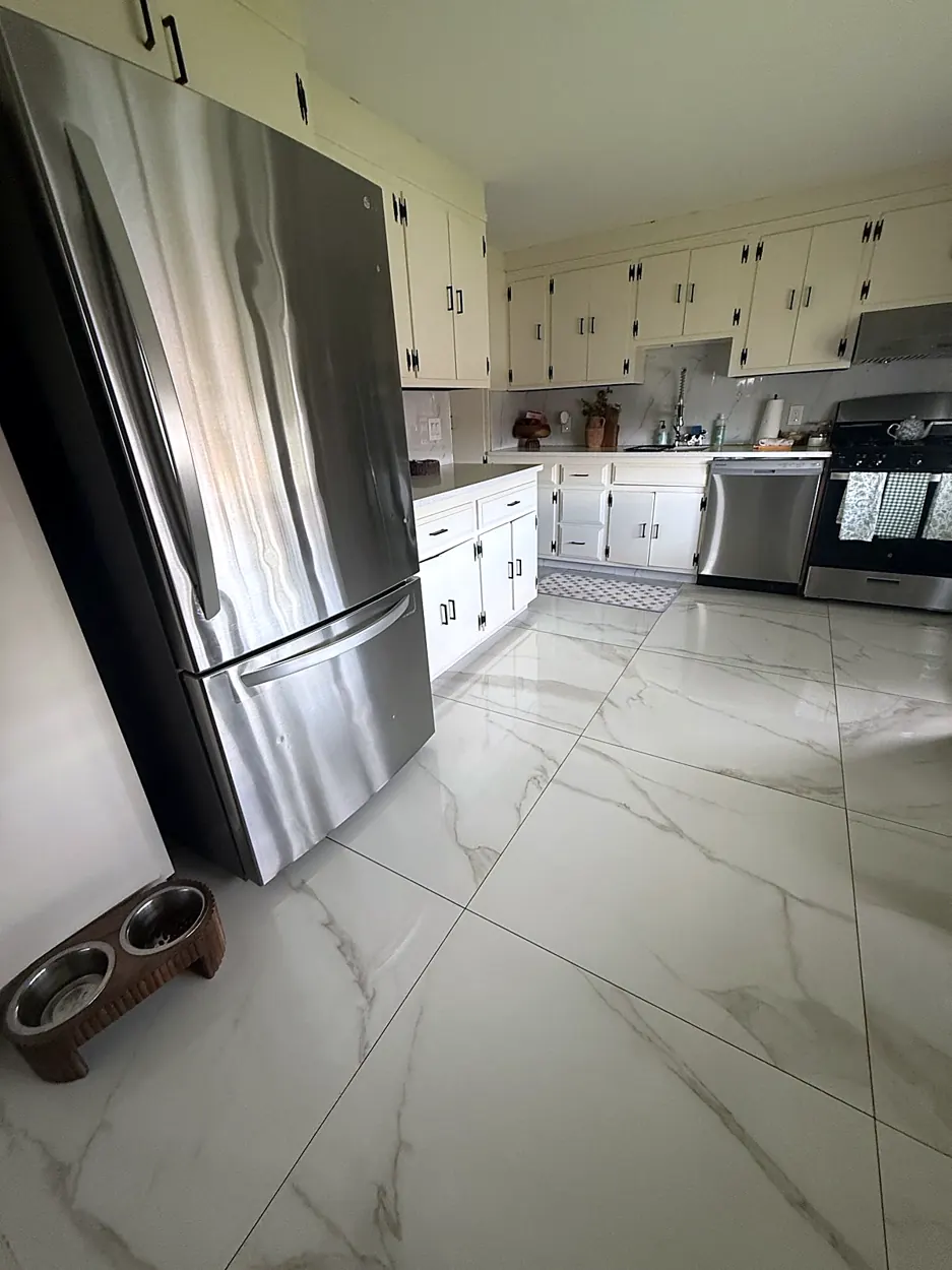 Kitchen (marble tile floor, stainless fridge) after a home cleaning in Elmwood Park, NJ