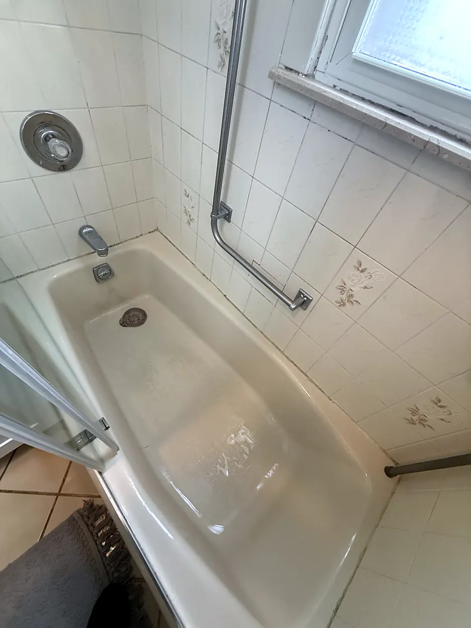 Bathtub (white tile, grab bar) after a home cleaning in Elmwood Park, NJ