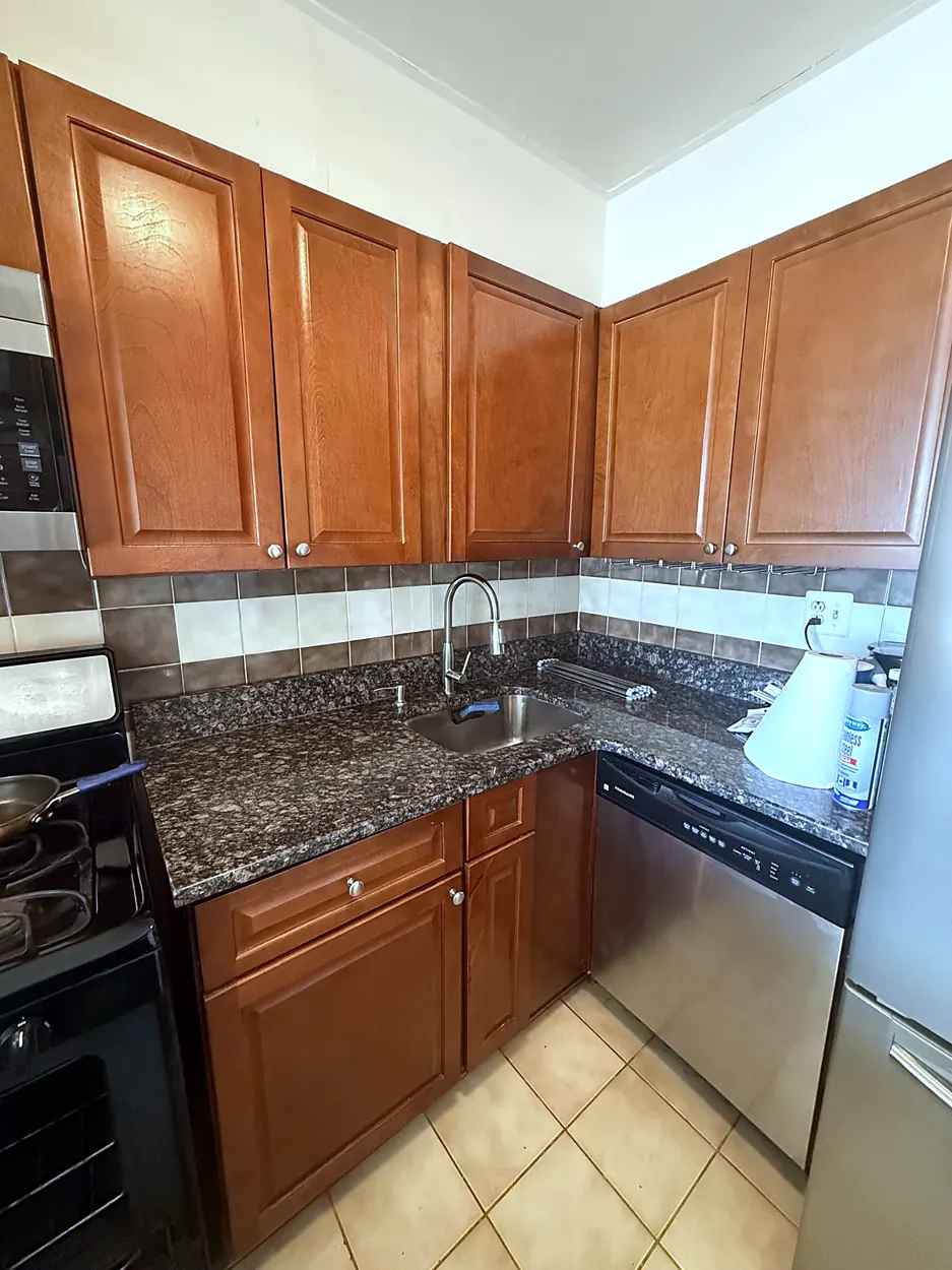 Kitchen (cherry cabinets, granite counters) after a move-in/move-out cleaning in Guttenberg, NJ