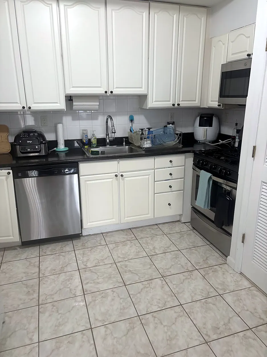 Kitchen (white cabinets, tile floor) after a cleaning in Hoboken, NJ