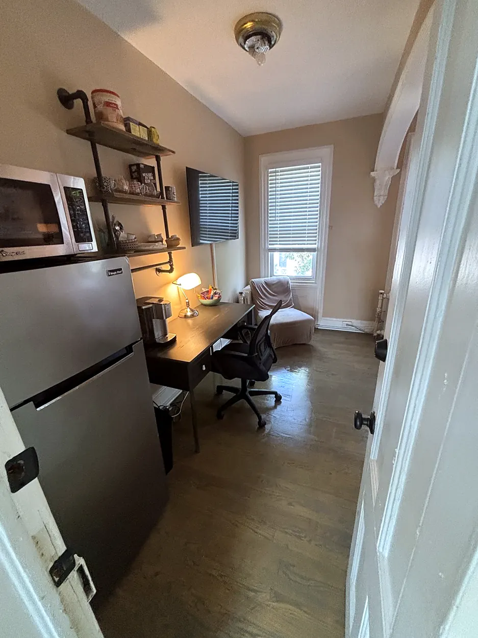 Home office (desk, wood floor) after an Airbnb turnover in Jersey City, NJ