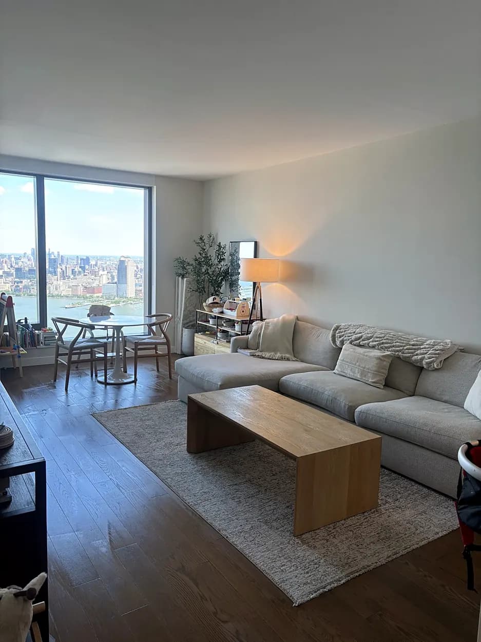 Living room (Manhattan view, sectional sofa) after a home cleaning in Jersey City, NJ