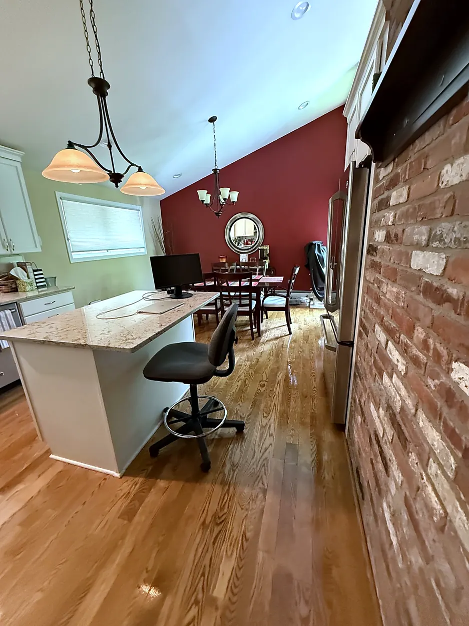 Kitchen (granite island, brick wall) after a home cleaning in Montville, NJ
