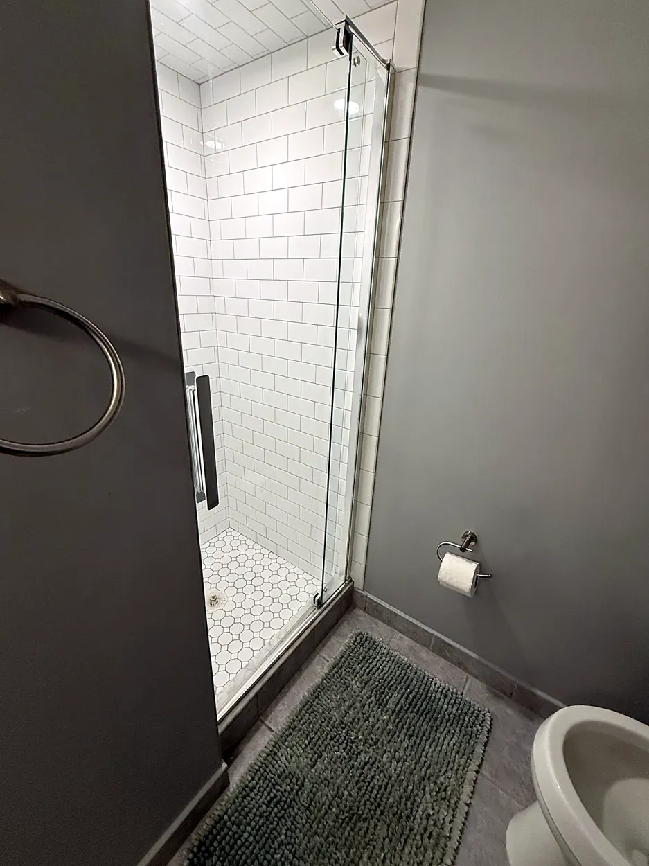 Shower (white subway tile, glass door) after a home cleaning in Nutley, NJ