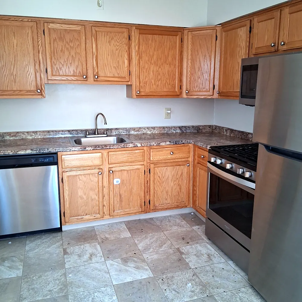 Kitchen (oak cabinets, stainless range) after a move-in/move-out cleaning in Pompton Lakes, NJ