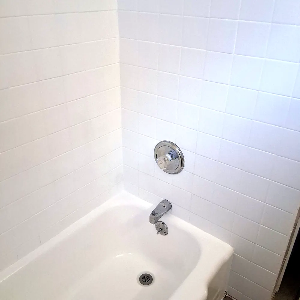 Bathtub (white tile, chrome fixtures) after a move-in/move-out cleaning in Pompton Lakes, NJ