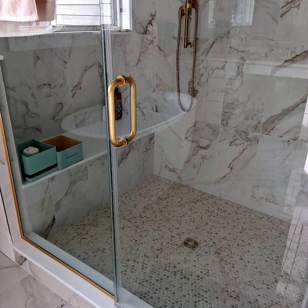 Shower (marble tile, brass fixtures) after a home cleaning in River Vale, NJ