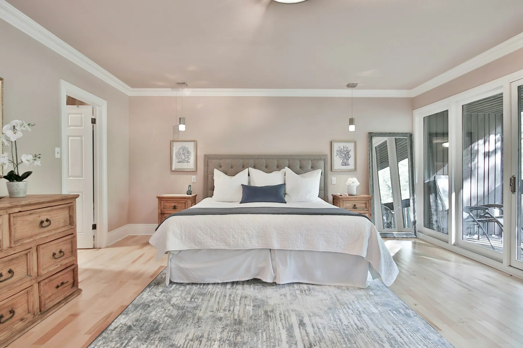 Bedroom with a freshly made bed and a tufted headboard