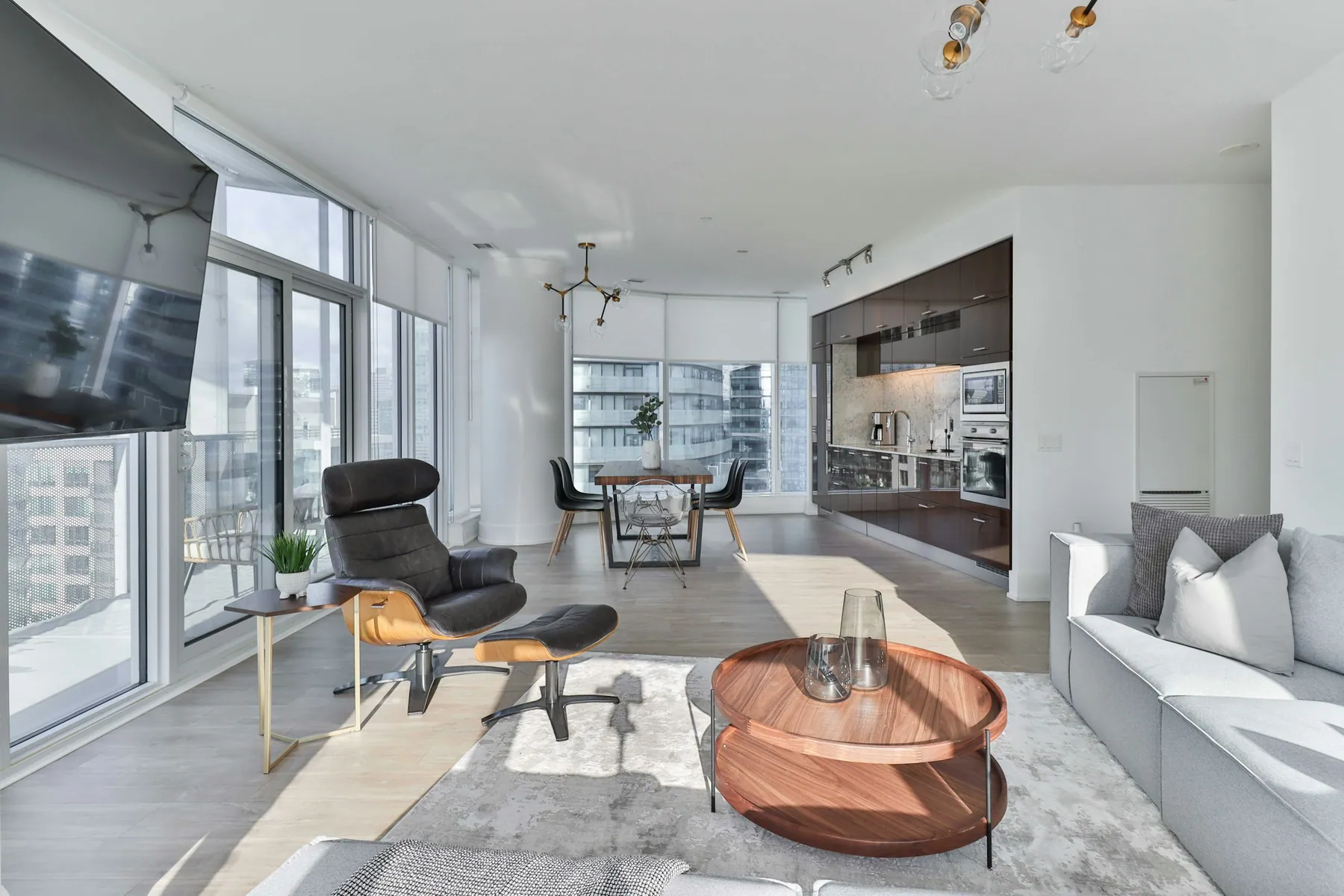 Apartment living room with floor-to-ceiling windows and an open-plan kitchen