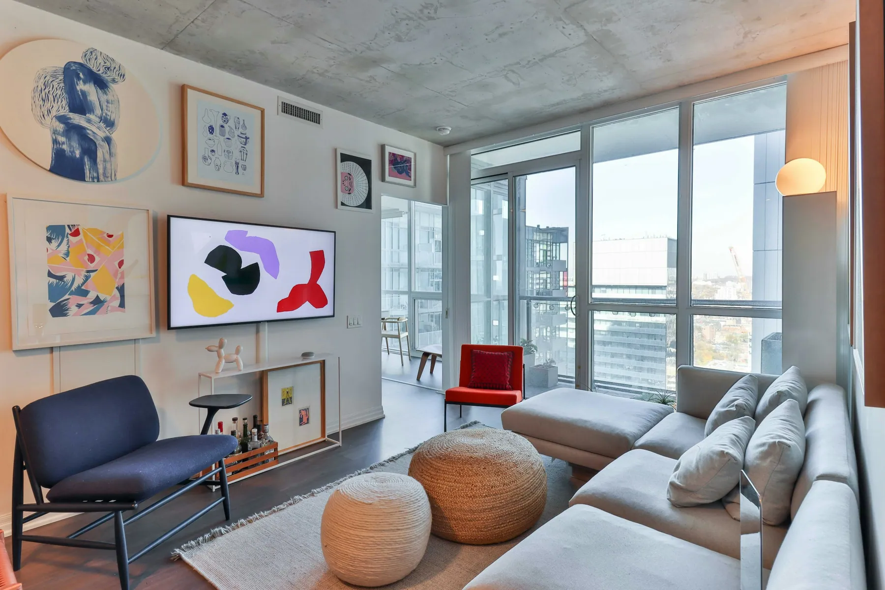 Colorful apartment living room with city views and a sectional sofa