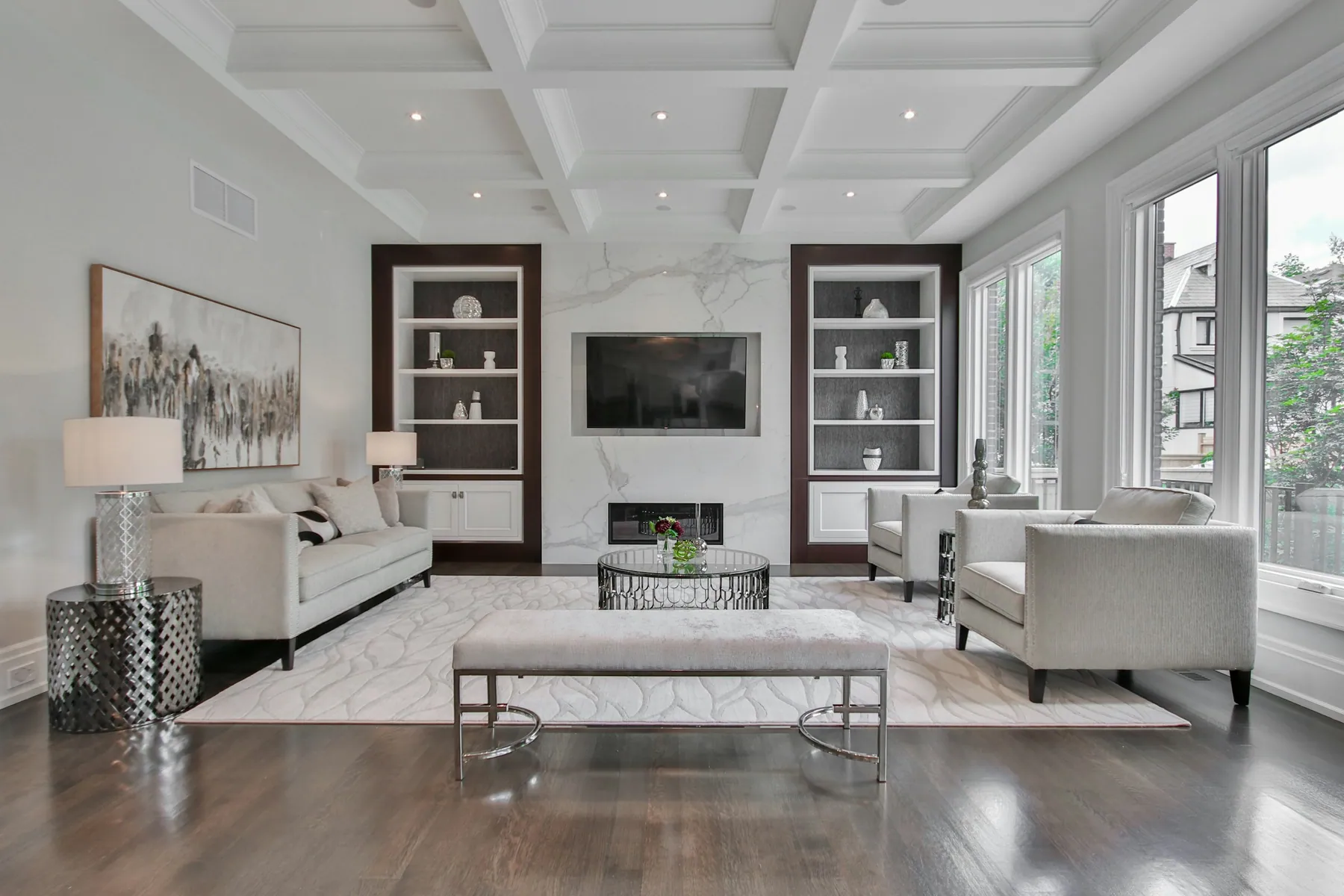 Formal living room with a coffered ceiling, built-ins and fireplace