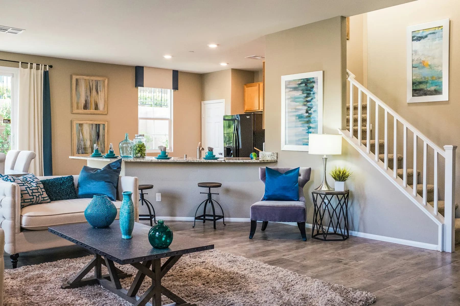 Open living room and kitchen with a staircase and hardwood floor