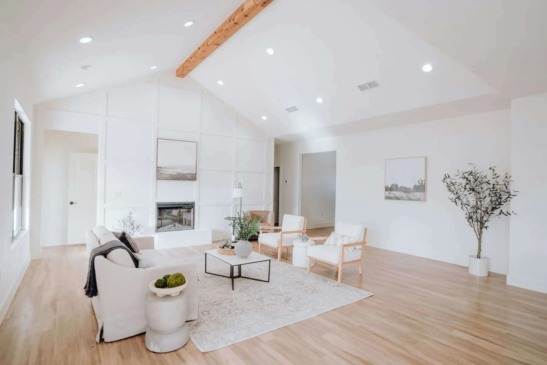 New-construction great room with a board-and-batten wall and fireplace