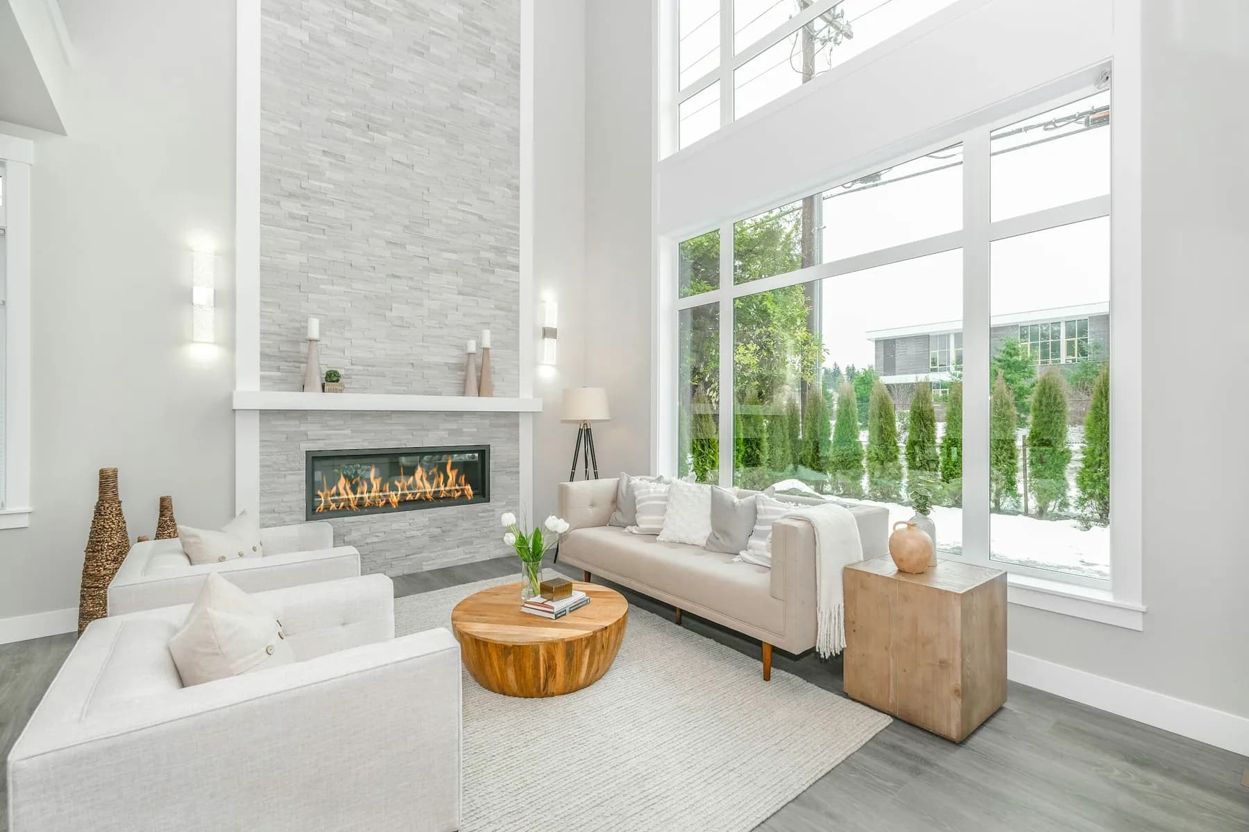 New-build great room with a linear fireplace and tall windows