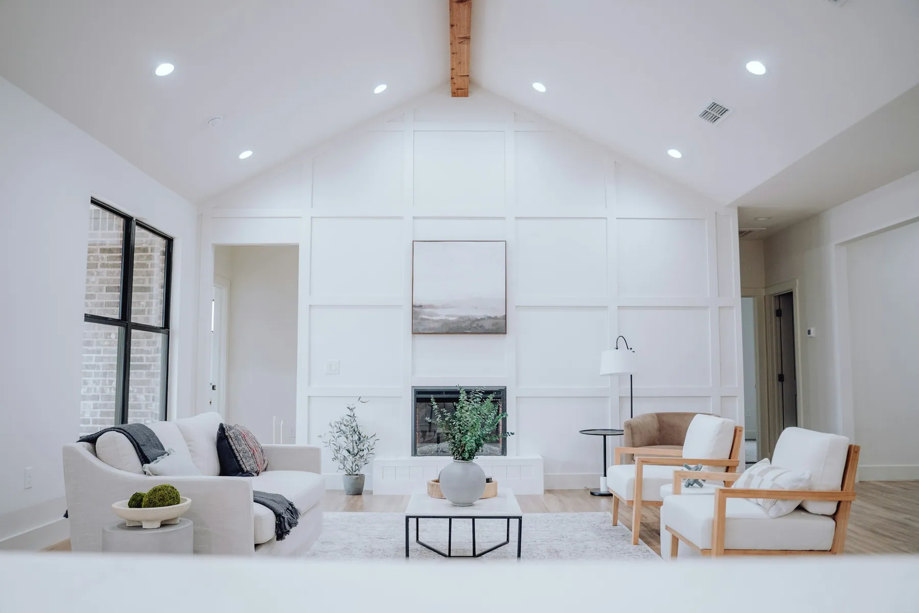 Bright new great room with a vaulted ceiling and wood beam
