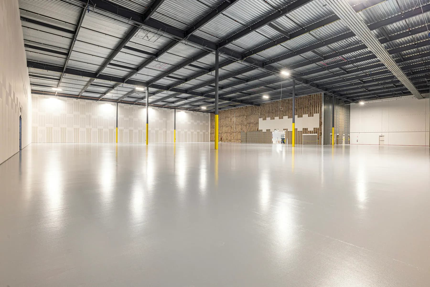 Large empty warehouse with a glossy coated floor