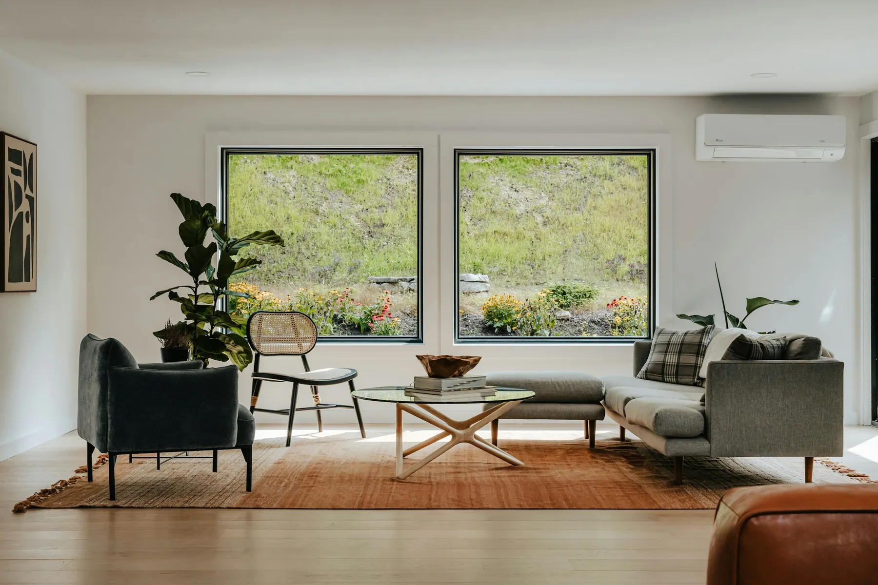 Living room with large black-frame windows and soft daylight