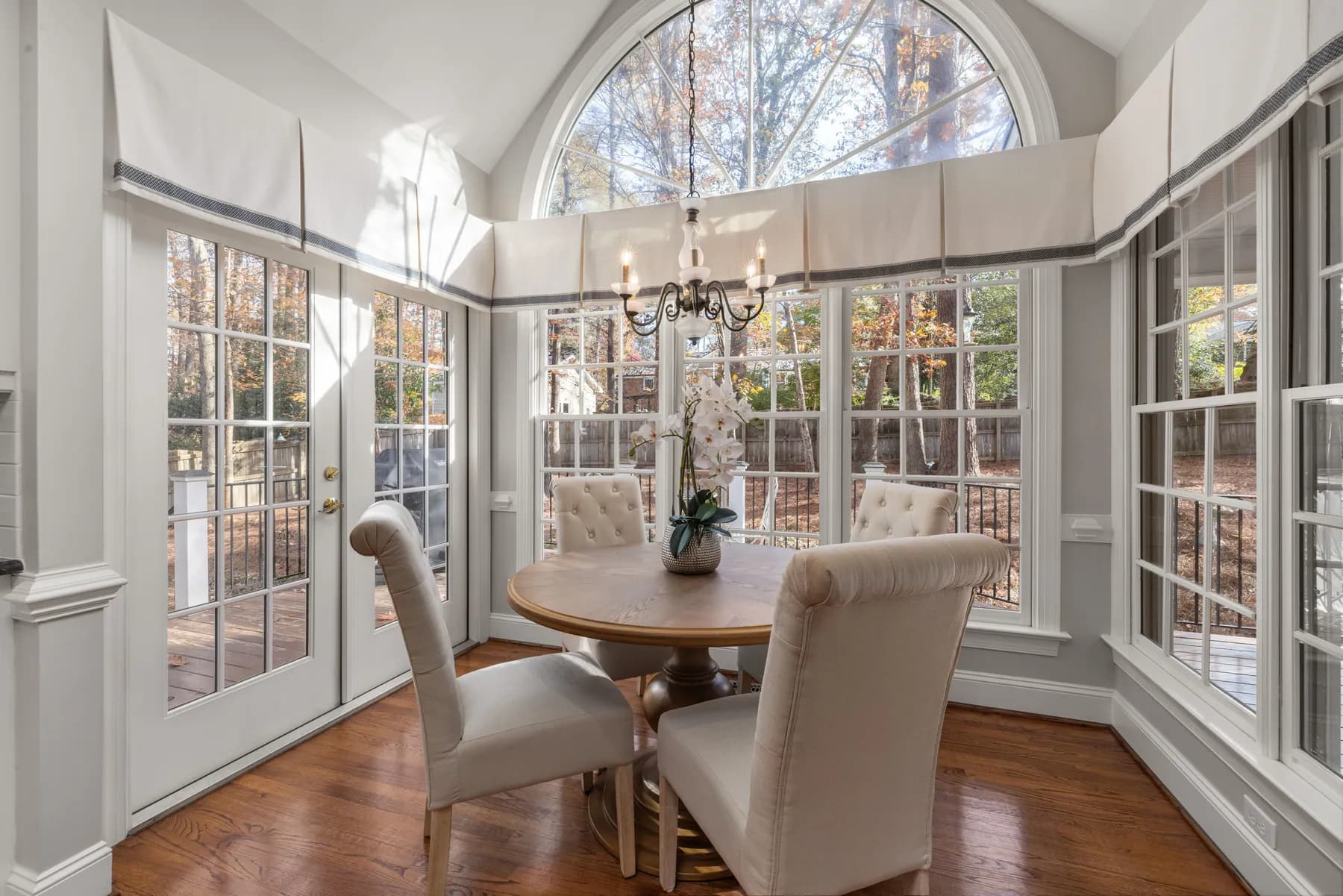 Breakfast nook with an arched transom and bay windows